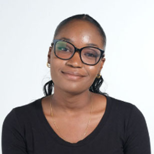 iuGO Digital - A woman with glasses and a black shirt smiles slightly at the camera against a plain white background.